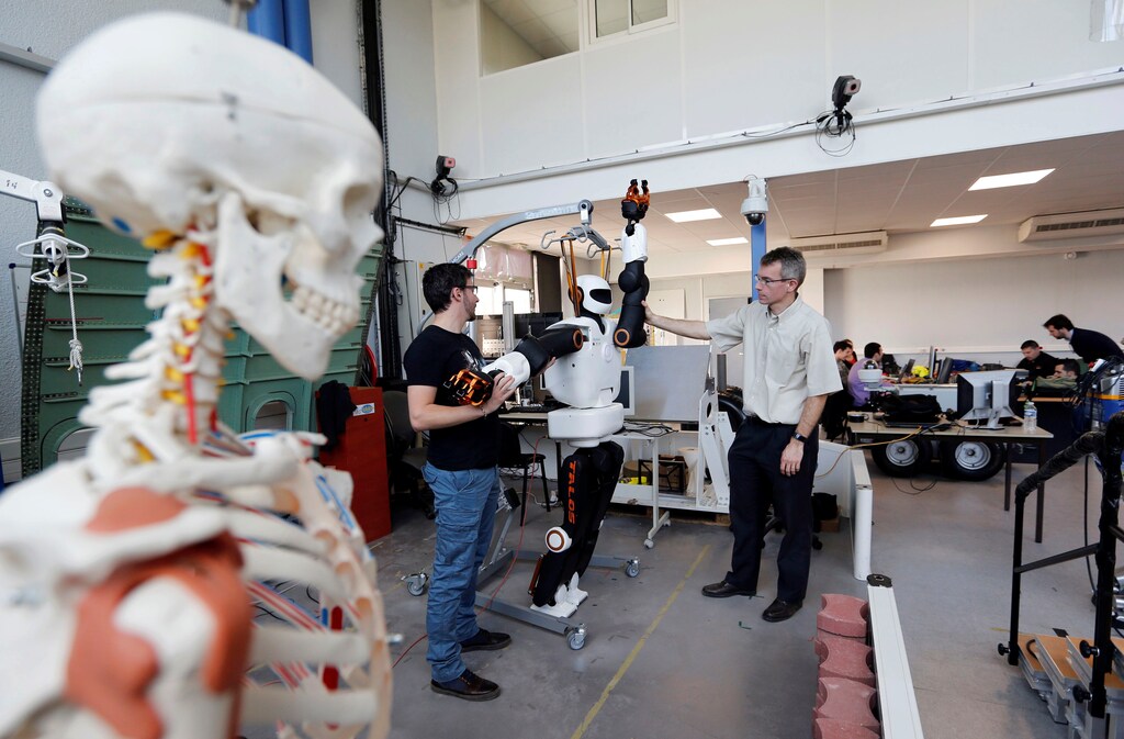 Olivier Stasse (R), Head of Research at CNRS, tests Pyrene, a humanoid robot handyman, developped by the French lab Laas (Laboratory for Analysis and Architecture of Systems) of the CNRS in Toulouse, France, February 21, 2017. REUTERS/Regis Duvignau - RTSZO4F