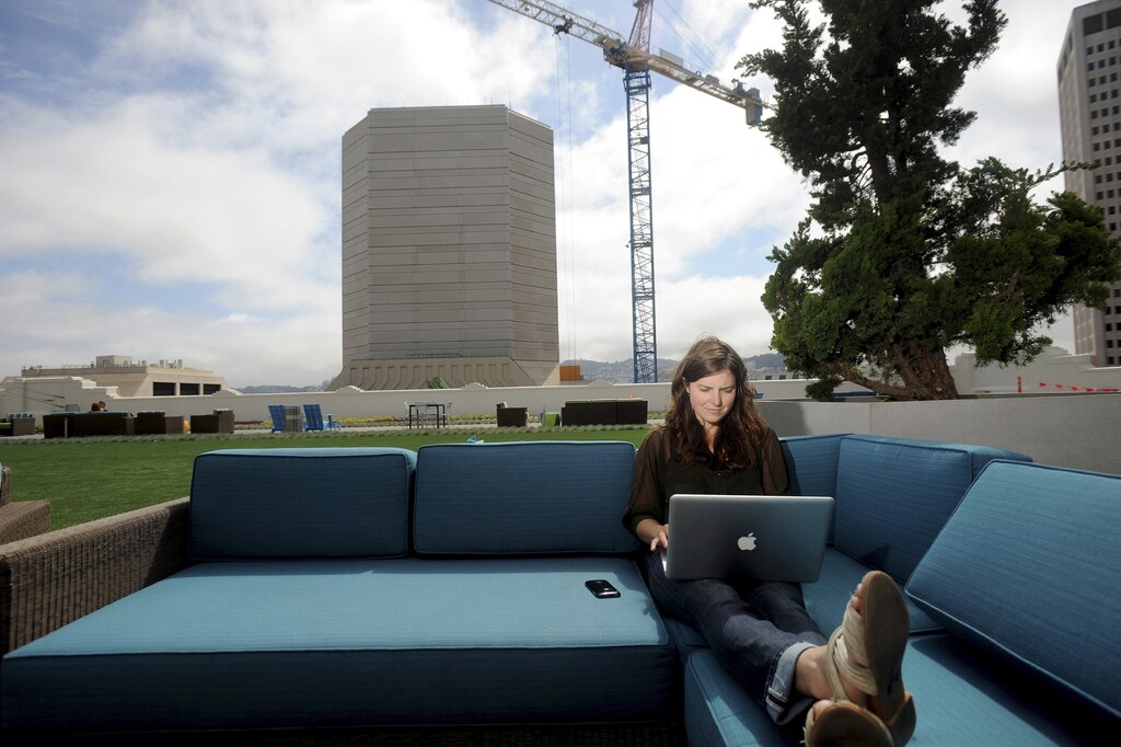 Jenna Sampson, a community relations manager at Twitter, works on the company's rooftop deck in San Francisco, California July 25, 2012. The Olympics have presented a prime opportunity for Twitter to position itself as a new media channel that complements TV broadcasts - and carries the big-name ads to match. REUTERS/Noah Berger (UNITED STATES - Tags: BUSINESS) - RTR35Y4M