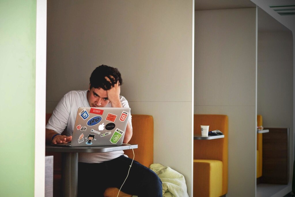 burnout man stressed out working laptop health productivity