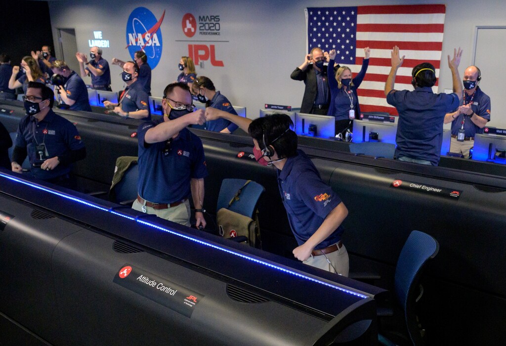Members of NASA's Perseverance rover team react in mission control after receiving confirmation the spacecraft successfully touched down on Mars, at NASA's Jet Propulsion Laboratory in Pasadena, California, U.S. February 18, 2021. Picture taken February 18, 2021. NASA/Bill Ingalls/Handout via REUTERS. MANDATORY CREDIT. THIS IMAGE HAS BEEN SUPPLIED BY A THIRD PARTY. - RC2WVL9JKDBA