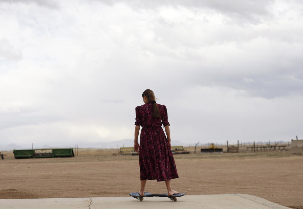Catalina rides a two-wheelsskateboard outside her home in the Mennonite community of Buenos Aires in the northern state of Chihuahua February 16, 2012. Over 80,000 Mennonites live in Mexico after they established themselves for the first time in the 1920s. Mennonites arrange their lives according to their religious beliefs; they have their own educational system and do not participate in the government or serve in the military. Their origins date back to Switzerland in the 16th century as part of the Reformation until a movement was founded by the Dutch priest Menno Simon who believed in a different interpretation of the scriptures, hence the name Mennonites, meaning "Followers of Menno". Picture taken February 16, 2012. REUTERS/Jose Luis Gonzalez (MEXICO - Tags: SOCIETY RELIGION) - RTR2YCEP