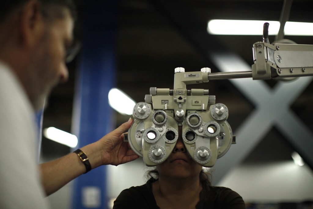 A woman receives an eye exam at the Care Harbor/LA free clinic in Los Angeles September 27, 2012. The clinic will give an estimated 4,800 patients free dental work, medical exams, screenings and immunizations over four days. REUTERS/Lucy Nicholson (UNITED STATES - Tags: HEALTH SOCIETY) - RTR38IF6