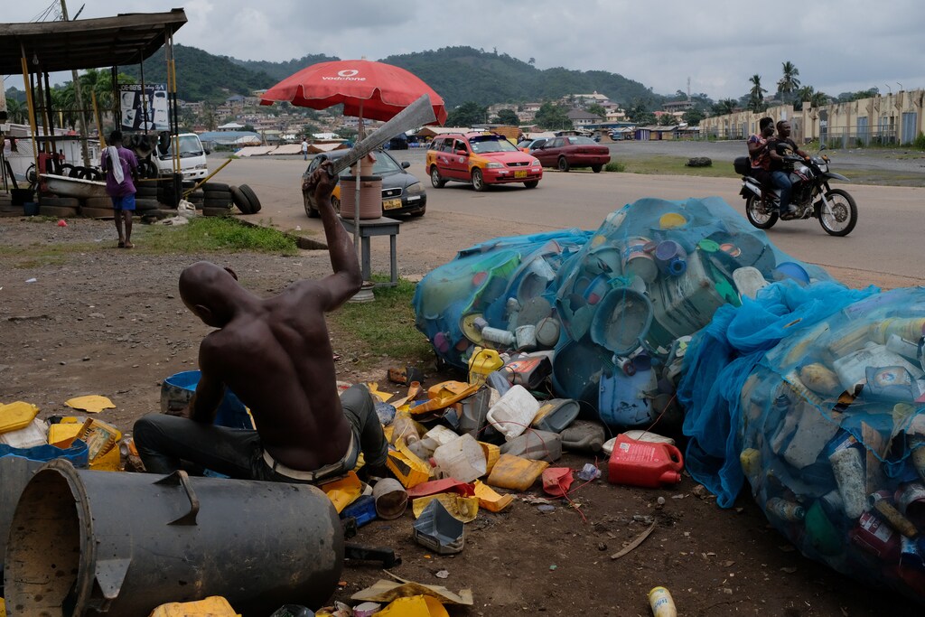 Worker breaks plastic scraps to be sold off to a recycling plant in Obuasi, Ghana, July 25, 2019. REUTERS/Francis Kokoroko