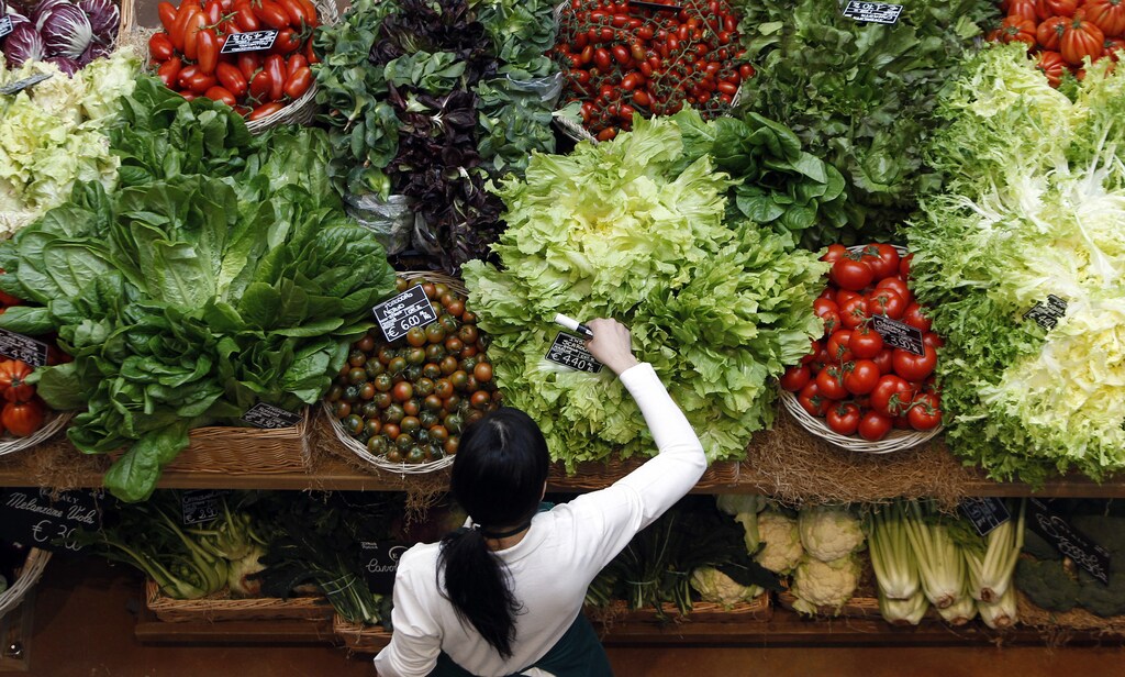 An employee arranges pricetags at a vegetables work bench during the opening day of upmarket Italian food hall chain Eataly's flagship store in downtown Milan, March 18, 2014. Eataly, which began with the idea that there should be a place to buy, eat and study high-quality Italian food and wine, has 25 food emporiums in the United States, Turkey, Japan and Dubai. REUTERS/Alessandro Garofalo (ITALY - Tags: SOCIETY FOOD BUSINESS) - GM1EA3J06CQ01
