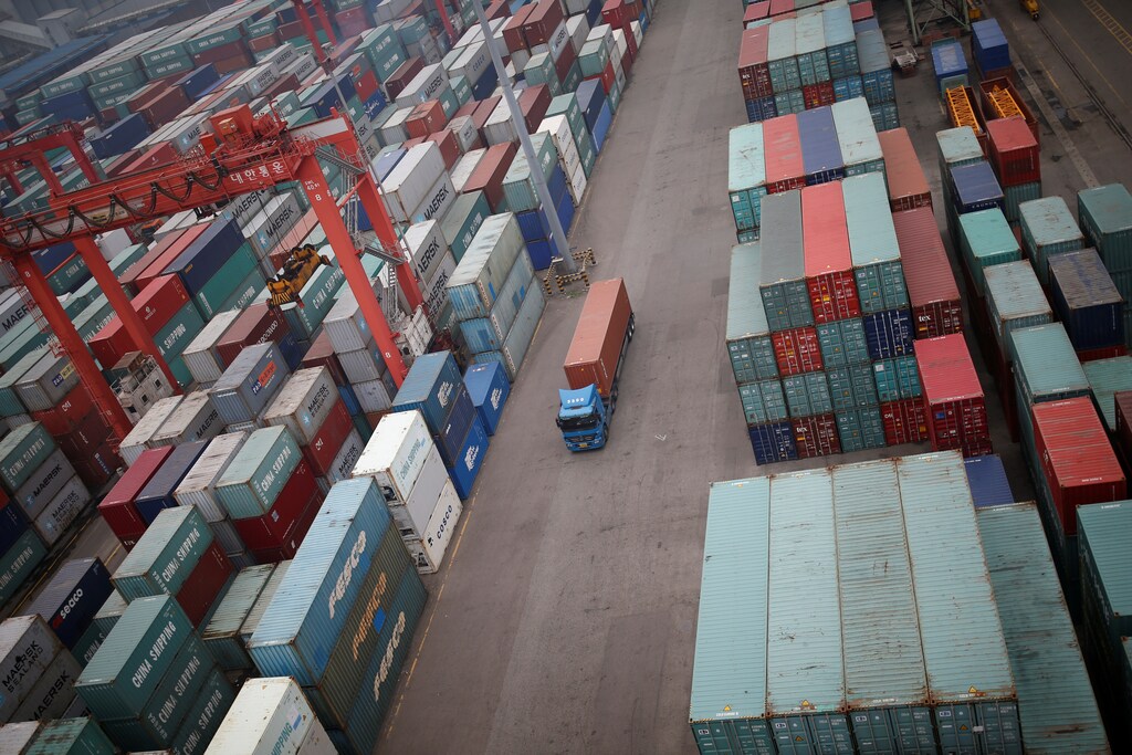 A truck drives between shipping containers at a container terminal at Incheon port in Incheon, South Korea, May 26, 2016.
