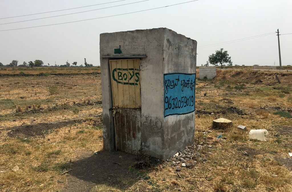 A toilet is pictured in a field outside a school near Jaikisan Camp village in the southern state of Karnataka, India, India, April 30, 2019. Picture taken April 30, 2019. REUTERS/Sachin Ravikumar - RC1C101B1A00