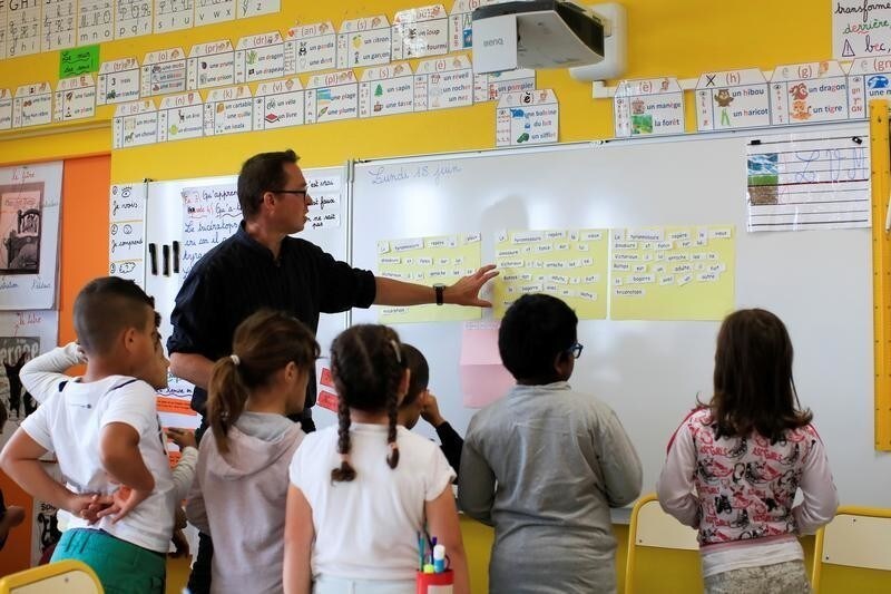 School children listen to their teacher Sebastien Ducoroy in their classroom at the Primary School Les Ormeaux in Montereau-Fault-Yonne near Paris, France, June 18, 2018. Picture taken on June 18, 2018.