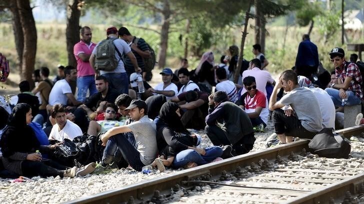 Migrants wait on the Greek side of the border to enter Macedonia near Gevgelija, Macedonia, en route to northern Europe, July 20, 2015. The European Union failed to reach a deal to resolve a migration crisis in the Mediterranean, and instead set a deadline of July 20 to reach an agreement on how to redistribute 40,000 asylum seekers currently in Italy and Greece.