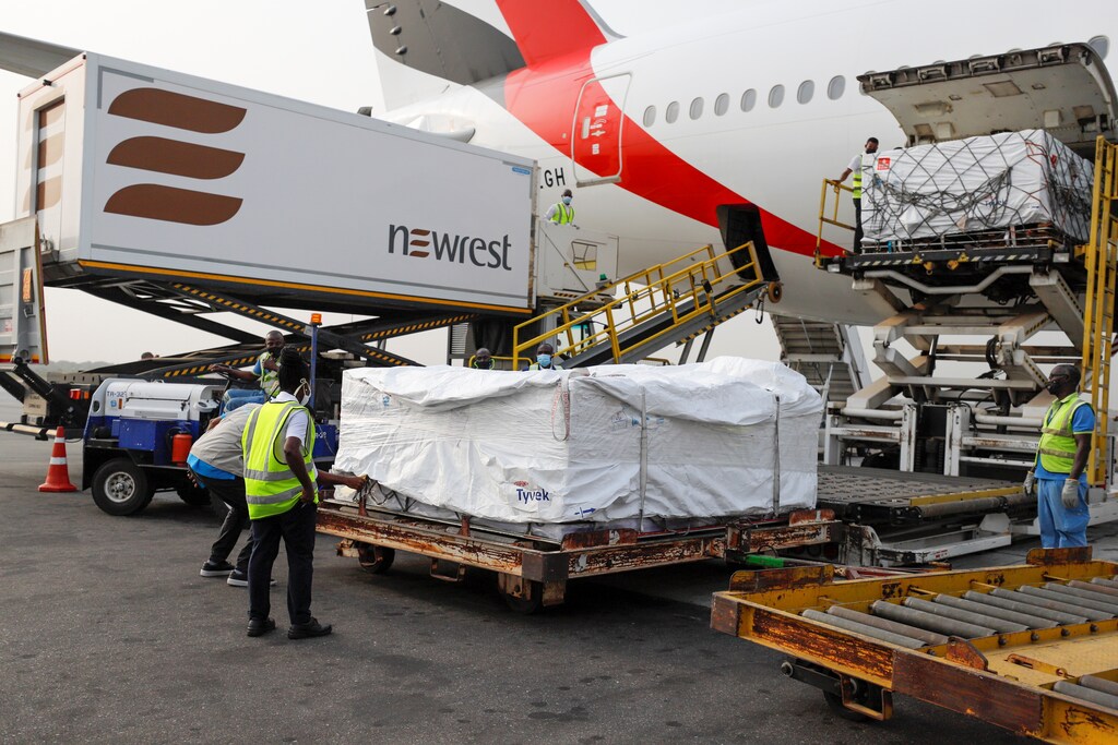 Workers offload boxes of AstraZeneca/Oxford vaccines in Ghana, the first of the COVAX vaccines to be delivered.