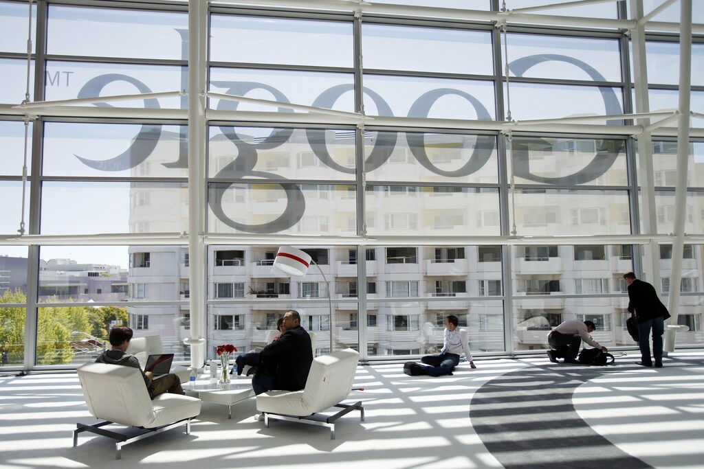 ttendees sits in front of a Google logo during Google I/O Conference at Moscone Center in San Francisco.
