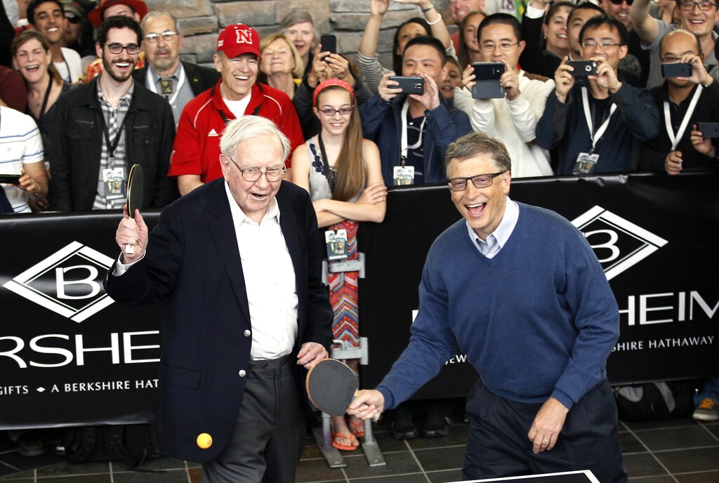 Berkshire Hathaway CEO Warren Buffett (L) and friend Bill Gates, founder of Microsoft, play table tennis at a Berkshire sponsored reception in Omaha, Nebraska May 4, 2014 as part of the company annual meeting weekend. The investment guru was peppered with questions at the meeting, part of a mostly festive weekend that Buffett calls "Woodstock for Capitalists," following concerns that Berkshire last year missed Buffett's five-year growth target for the first time in his 49 years at the helm. REUTERS/Rick Wilking (UNITED STATES - Tags: BUSINESS TPX IMAGES OF THE DAY) - GM1EA5509UY01