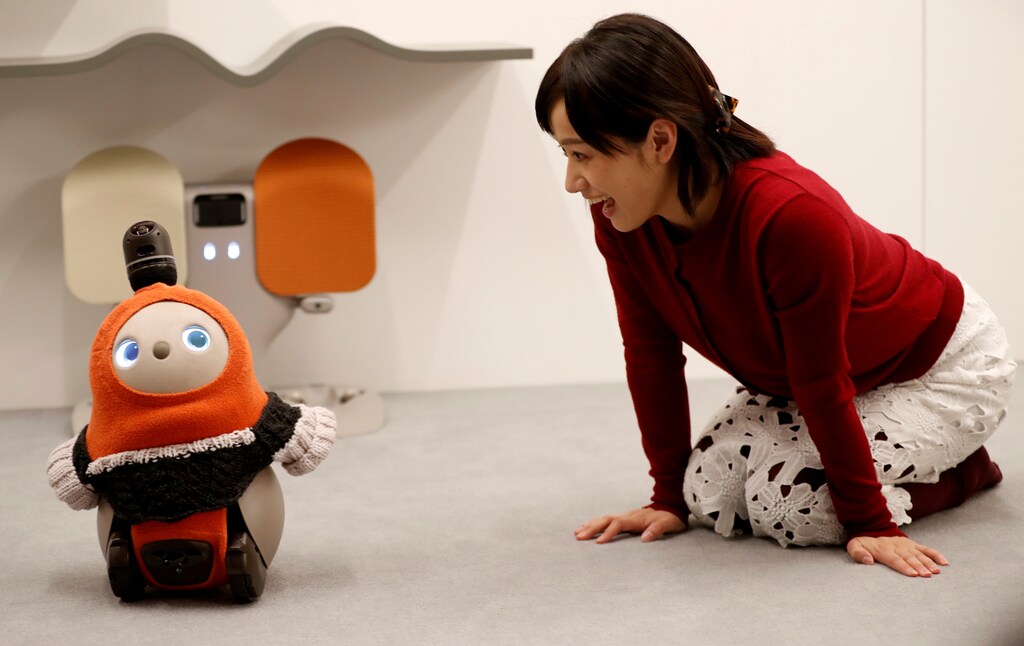 A woman calls up GROOVE X's new home robot LOVOT at its demonstration during the launching event in Tokyo, Japan, December 18, 2018. REUTERS/Kim Kyung-Hoon TPX IMAGES OF THE DAY - RC1BAD9B5D00