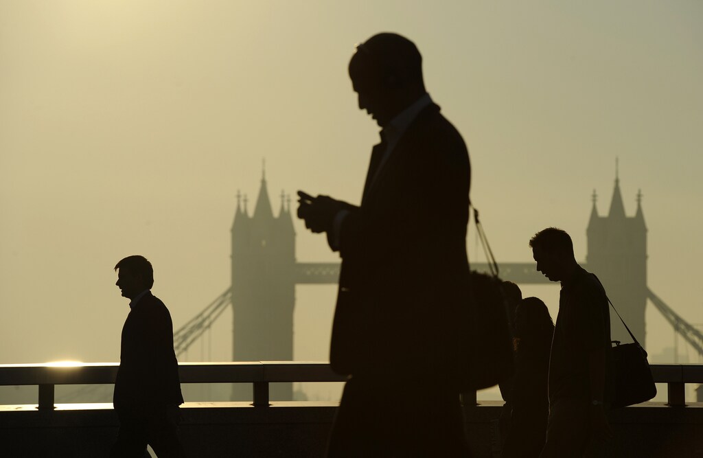 Workers cross London Bridge.