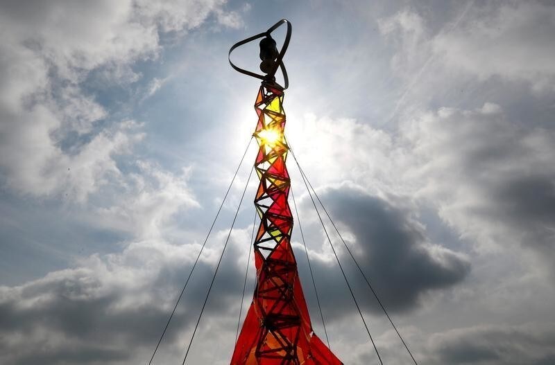 An "Eiffel Tower", 21-metre-high solar and wind power-generating construction called Green Energy Mill-tower, is seen as an alternative to polluting power generators at Belgium's music festival Pukkelpop in Hasselt, Belgium August 16, 2019. REUTERS/Francois Lenoir TPX IMAGES OF THE DAY - RC18B510DE50