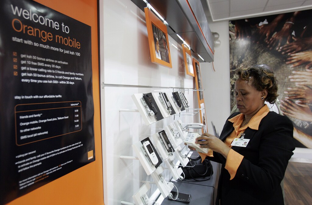 A Telkom Kenya, Africa employee arranges new mobile phones at one of their outlets in the capital Nairobi, September 17, 2008. Telkom Kenya, a unit of France's Orange launched a mobile phone service on Wednesday and said users of its fixed and mobile lines would reach 1.5 million in a year. REUTERS/Antony Njuguna (KENYA)