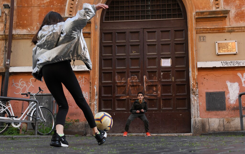 Children play football on the streets of Rome, amid the spread of coronavirus disease (COVID-19) continues in Rome, Italy, April 23, 2020.