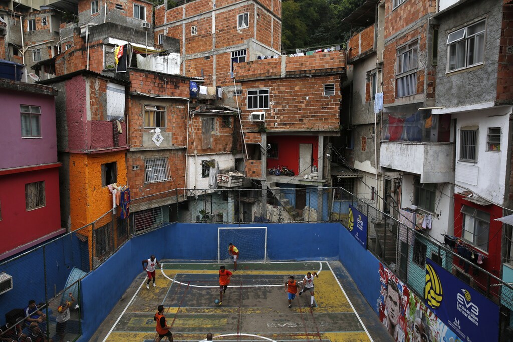 People take part in a soccer match held at the Tavares Bastos slum in Rio de Janeiro May 18, 2014. The World Cup will be held in 12 cities in Brazil from June 12 till July 13. REUTERS/Pilar Olivares (BRAZIL - Tags: SPORT SOCCER TPX IMAGES OF THE DAY)FOR BEST QUALITY IMAGE ALSO SEE: GF10000109702 - GM1EA5J074H01