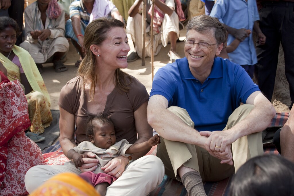 Photo Credit to: ©Bill & Melinda Gates Foundation/Prashant Panjiar.INDIA / Bihar / Jamsaut village / 23 March 2011 Bill and Melinda Gates interacting with women of the Musahar community in their locality of Jamsaut village on 23 March 2011 . In Melinda's lap is Rani, the child of Rungti Devi whose home Bill and she visited earlier.