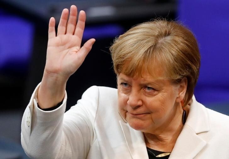 Chancellor Angela Merkel waves during a session of the German lower house of parliament Bundestag to elect a new chancellor, in Berlin, Germany, March 14, 2018. REUTERS/Kai Pfaffenbach TPX IMAGES OF THE DAY