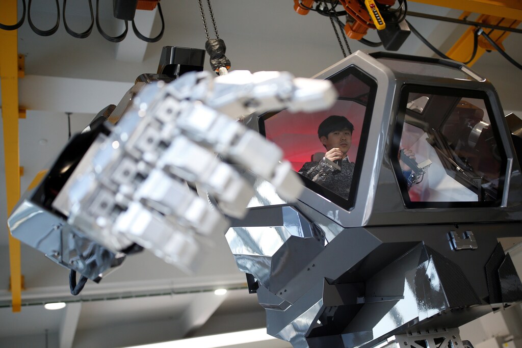 An employee controls the arms of a manned biped walking robot "METHOD-2" during a demonstration in Gunpo, South Korea, December 27, 2016.