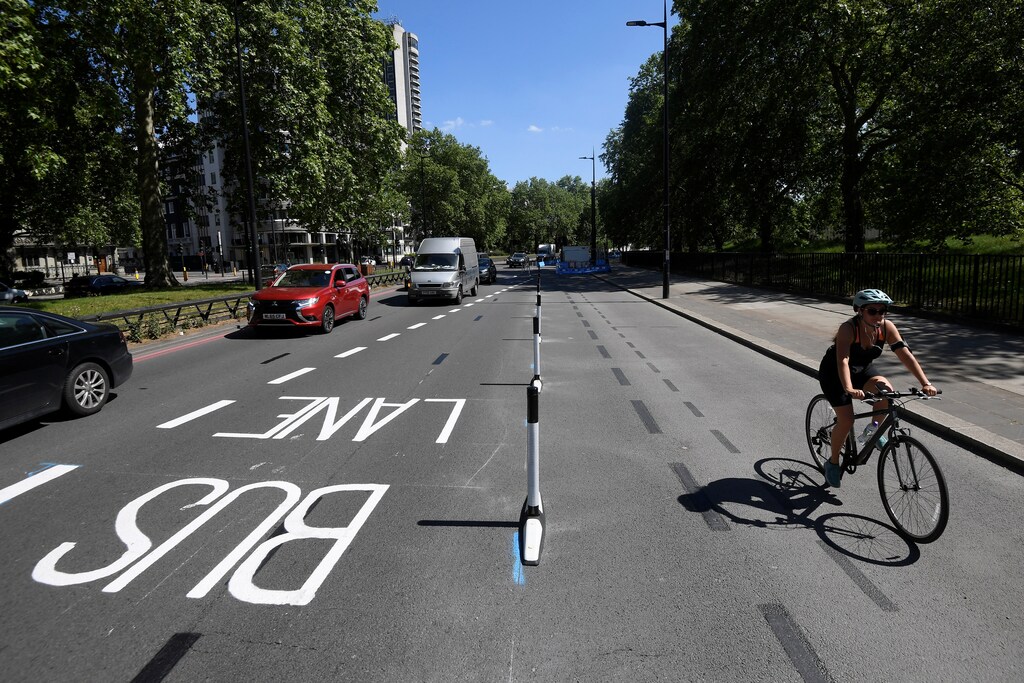 A cyclist rides along a newly created bicycle lane by Transport for London on Park Lane in London, following the outbreak of the coronavirus disease (COVID-19), London, Britain, May 21, 2020. REUTERS/Toby Melville - RC22TG9B5BLJ