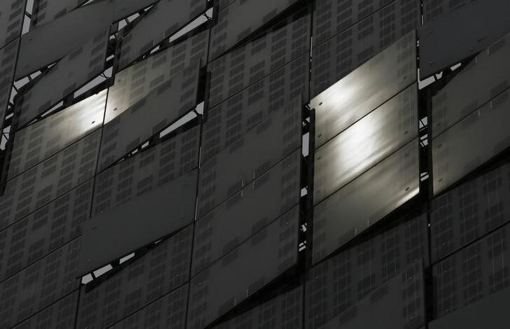 Sunlight is reflected off a LED display combined with China's first photovoltaic system integrated into a glass wall with solar technology outside a hotel in Beijing in this picture taken July 7, 2010. Solar companies, once prized for their astronomical growth prospects, have come under scrutiny by U.S. regulators for alleged accounting irregularities, sparking fears that more cases could start to surface in the months ahead. Picture taken July 7, 2010. To match Analysis SOLAR-ACCOUNTING/ REUTERS/Bobby Yip (CHINA - Tags: BUSINESS ENERGY)