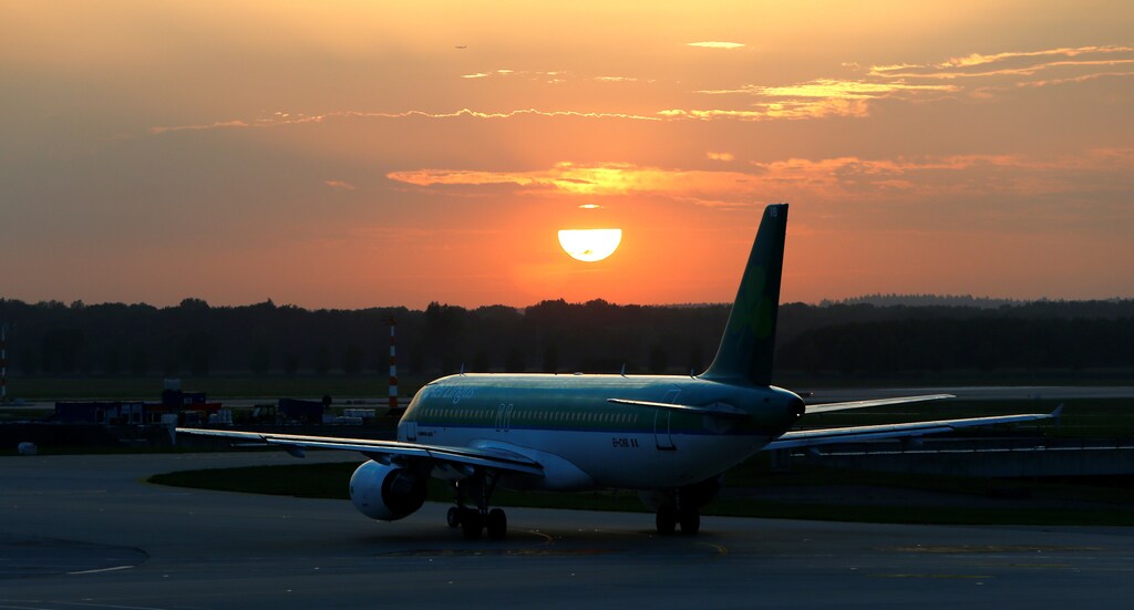 Airplane leaves airport in Munich during sunset, Germany August 3, 2017. Picture taken August 3, 2017. REUTERS/Michaela Rehle - RTS1AF4K