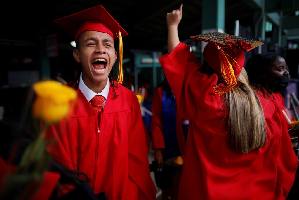 High school seniors celebrate after receiving their diploma in mortar boards