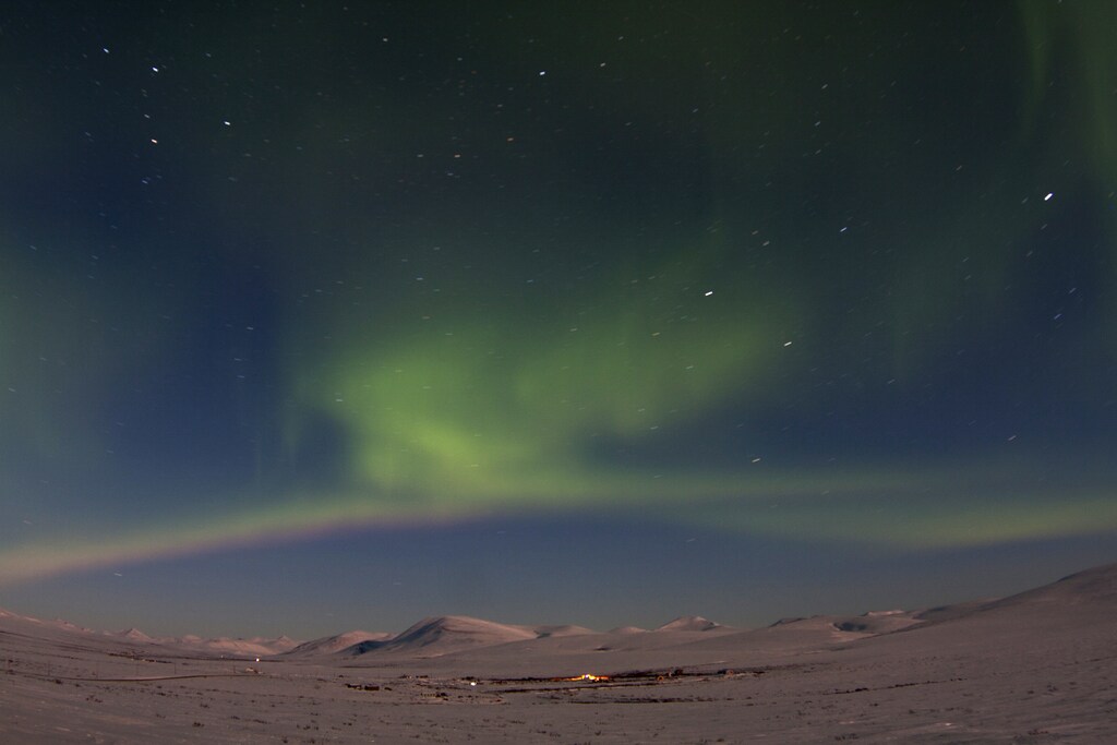 The aurora borealis is seen from Mile 7 on Beam Road above snow-covered tundras near Nome, Alaska March 10, 2012. A solar storm that shook the Earth's magnetic field on Thursday spared satellite and power systems as it delivered a glancing blow, although it could still intensify until early Friday, U.S. space weather experts said. REUTERS/Oscar Avellaneda-Cruz (UNITED STATES - Tags: ENVIRONMENT TPX IMAGES OF THE DAY) - GM1E83A1ROW01
