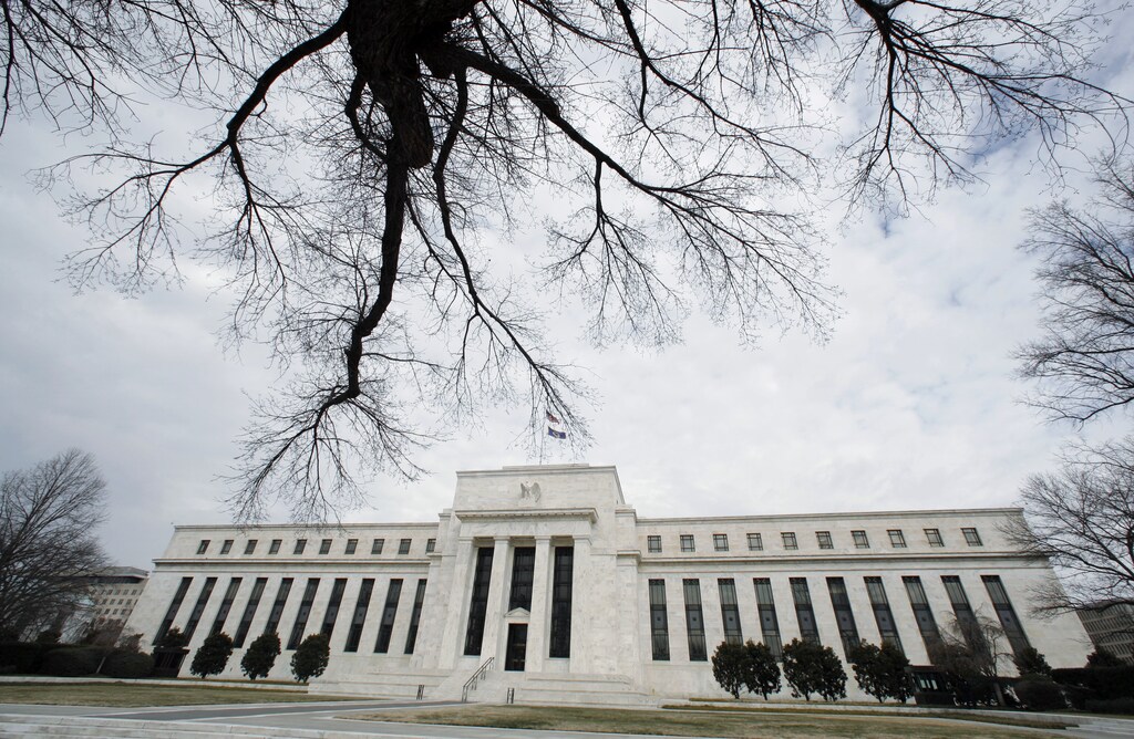 A wintry sky hangs over the Federal Reserve Building in Washington January 22, 2008. The U.S. Federal Reserve on Tuesday slashed U.S. interest rates by a hefty three-quarters of a percentage point, the biggest rate cut in more than 23 years, in an emergency bid to lend support to a U.S. economy some fear is on the verge of recession. REUTERS/Kevin Lamarque (UNITED STATES) - GM1DXCEYVGAA