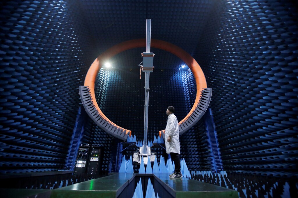 An engineer stands under a base station antenna of 5G in Huawei's SG178 multi-probe spherical near-field testing system at its Songshan Lake Manufacturing Center in Dongguan, Guangdong province, China May 30, 2019. Picture taken May 30, 2019. REUTERS/Jason Lee TPX IMAGES OF THE DAY - RC1B87A91DB0