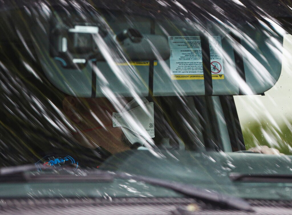 A medic wears a mask while driving an ambulance with a resident from the Life Care Center of Kirkland, a long-term care facility linked to several confirmed coronavirus cases, in Kirkland, Washington, U.S. March 6, 2020. REUTERS/Lindsey Wasson? - RC2JEF9G5Y04