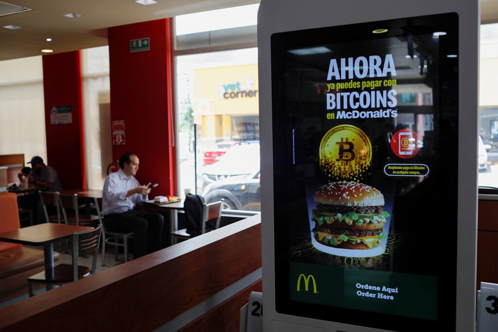 A sign that reads "Now you can pay with your bitcoins at McDonald's" is seen in a McDonald's restaurant, where the cryptocurrency is accepted as a payment method, in Antiguo Cuscatlan, El Salvador September 8, 2021.