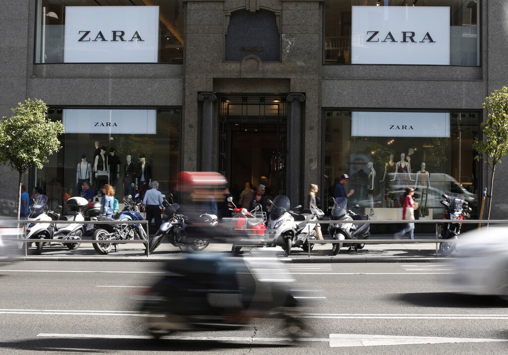 A scooter passes in front of a Zara store in Madrid, Spain, June 15, 2016. REUTERS/Paul Hanna - RTX2GBIB