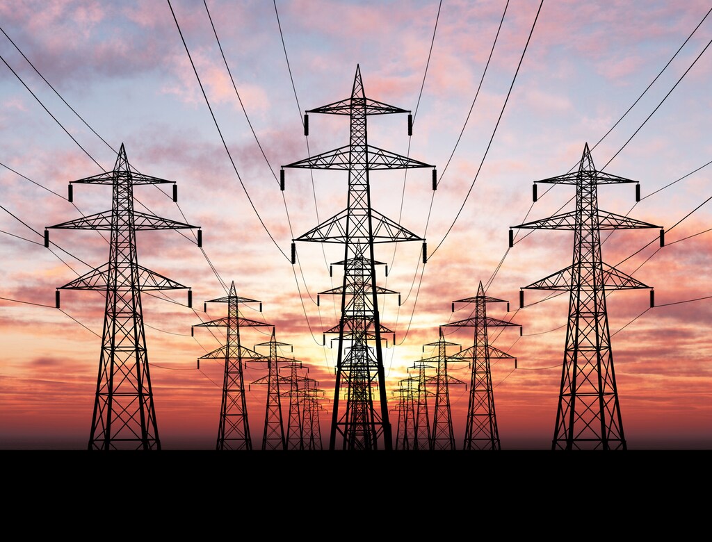 Electric power lines over sunrise; AI data centres