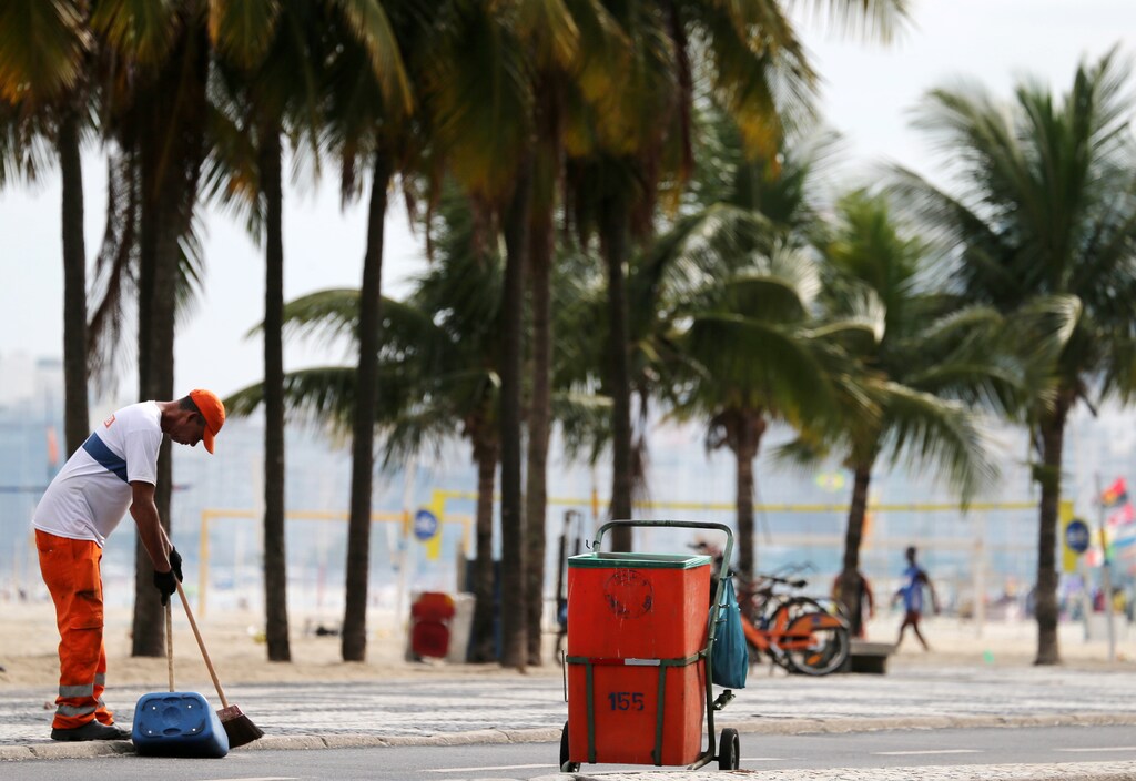 A worker from a public cleaning company collects garbage on Copacabana beach in Rio de Janeiro, Brazil February 26, 2019. REUTERS/Sergio Moraes - RC17C157C1C0