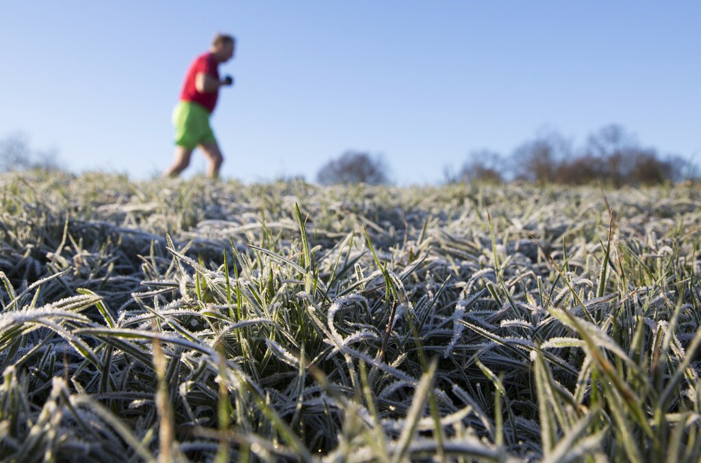 A man runs through a frost covered field in Hampstead Heath in north London December 29, 2014. Last night, temperatures in Britain fell to their lowest recorded levels of the year, local media reported, REUTERS/Neil Hall