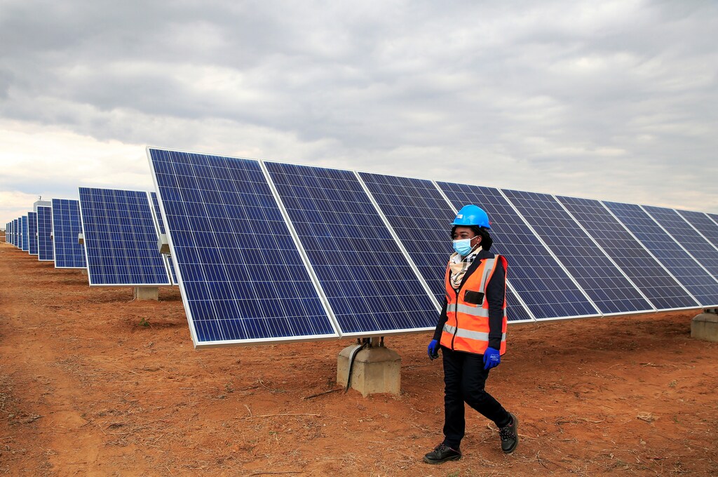 A worker walks past solar panels at Centragrid power plant in Nyabira, Zimbabwe, June 22, 2020. Picture taken June 22, 2020. REUTERS/Philimon Bulawayo - RC2XEH9KFHI5