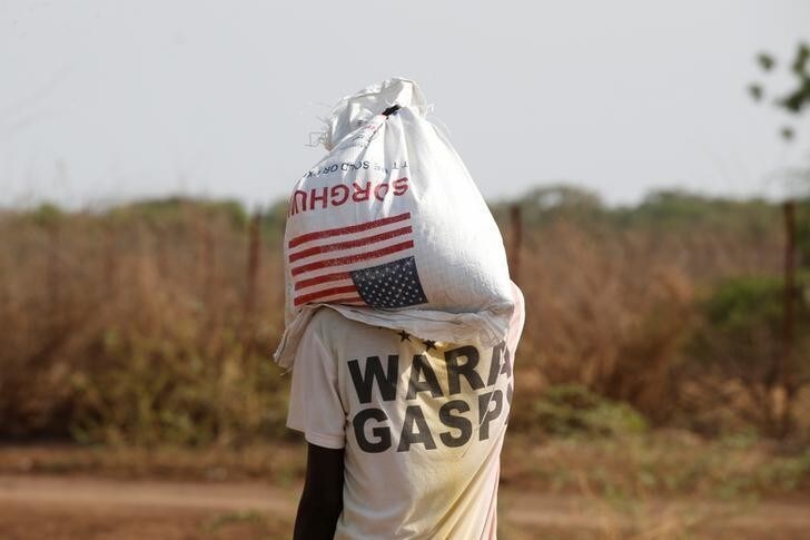 A man carries a bag of food aid at the Kakuma refugee camp in northern Kenya, March 6, 2018. Picture taken March 6, 2018. REUTERS/Baz Ratner