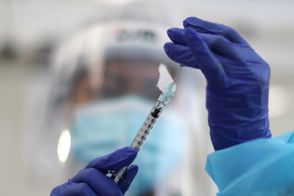 A healthcare worker prepares a Pfizer coronavirus disease (COVID-19) vaccination in Los Angeles, California.