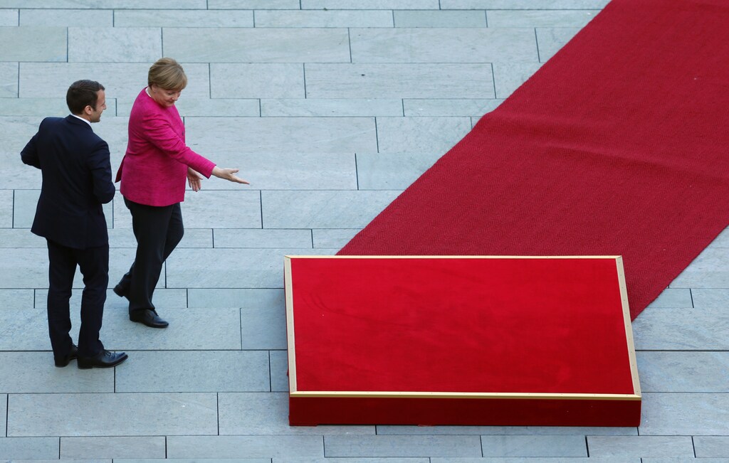 German Chancellor Angela Merkel and French President Emmanuel Macron arrive at a ceremony at the Chancellery in Berlin, Germany, May 15, 2017. REUTERS/Hannibal Hanschke TPX IMAGES OF THE DAY - RTX35YMB