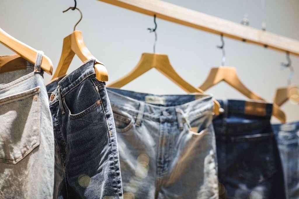 Demin jeans are seen hanging up in a shop.