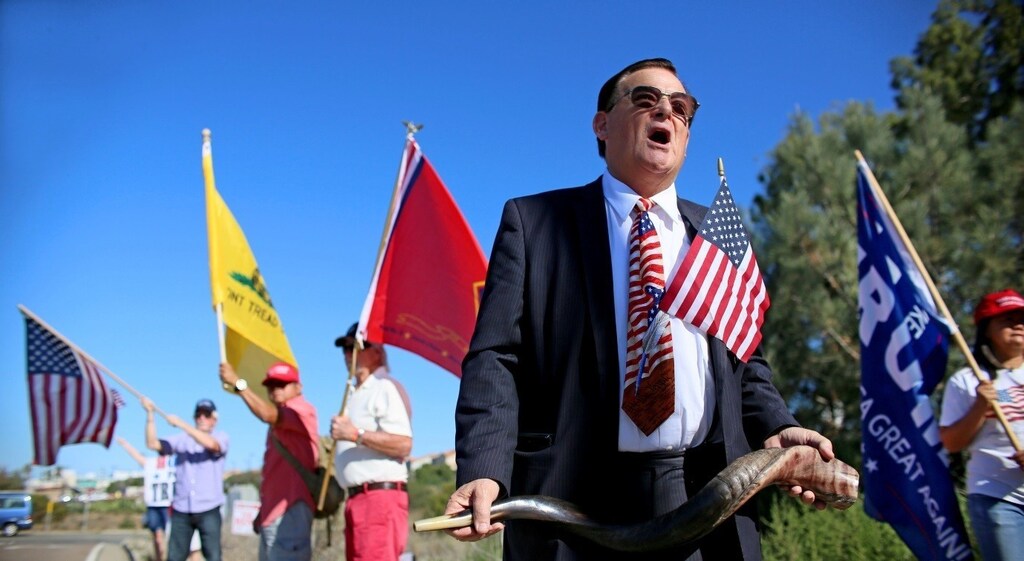 Demonstrator Wiley Drake attends a rally in support of President elect Donald Trump outside of Camp Pendleton in Oceanside, California
