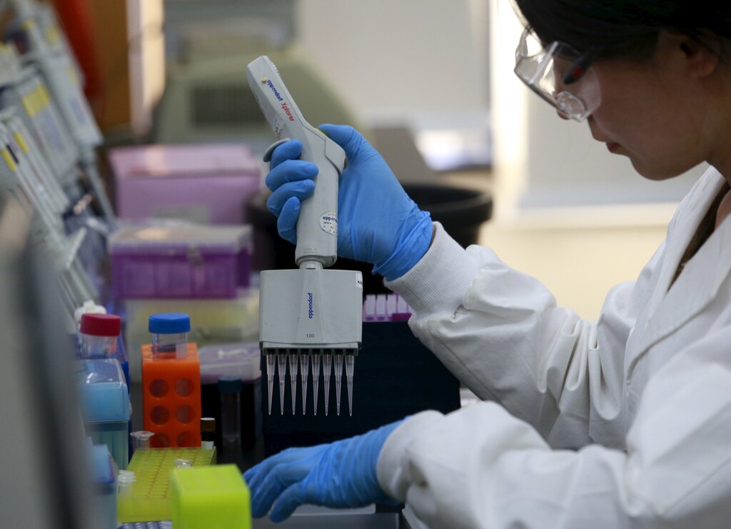 A researcher uses a pipette to develop assay to detect specific gene of corn at a lab in Syngenta Biotech Center in Beijing, China, February 19, 2016.