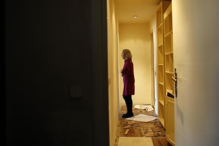 Monica Briceno stands in her apartment before learning that her eviction has been postponed in Madrid April 5, 2013. Briceno is a 70 year-old separated woman living on a pension of 364.90 euros ($475) and suffering from Alzheimer's disease. She has an advanced cognitive impairment and an eviction from what was her home for the last 40 years could cause an irreparable damage. Clinical studies prove that to remove an Alzheimer patient from her usual place of residence and routines can accelerate the progress of the disease. She's been living in a cheap rental apartment (old rental system) in Madrid since 1974. In 2001, after her legal separation, a judge gave her single tenancy rights. She has always complied with her payment obligations but the homeowner now claims the house for personal use. Authorities have postponed her eviction until the 24th of May, while her unemployed son Christian tries to relocate her through social services to a place where she can be properly taken care off. REUTERS/Juan Medina (SPAIN - Tags: POLITICS BUSINESS SOCIETY HEALTH TPX IMAGES OF THE DAY)