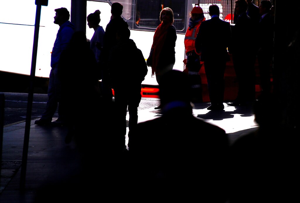 Shoppers wait to cross a main road and walk along a footpath near retail stores located in the central business district (CBD) of Sydney, Australia, July 7, 2017. REUTERS/David Gray - RTX3AEOG