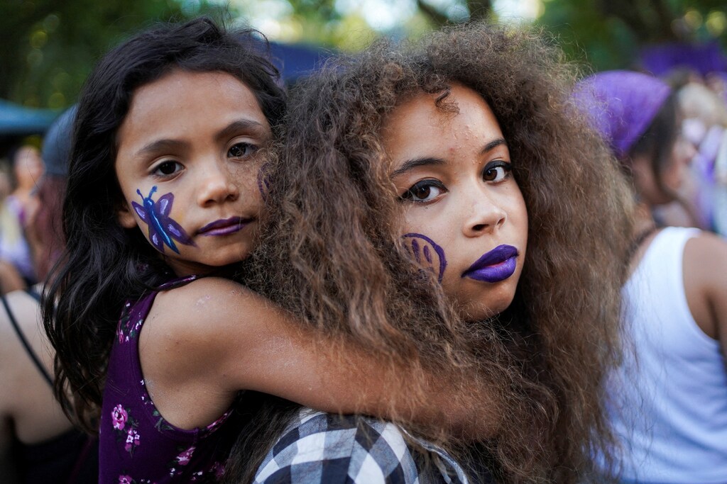 Sisters attend a march on International Women's Day, in Montevideo, Uruguay March 8, 2022. REUTERS/Mariana Greif TPX IMAGES OF THE DAY