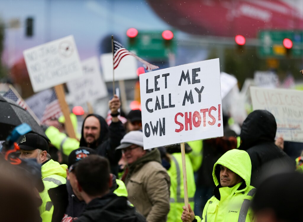 People protest a company's COVID-19 vaccine mandate in Everett, Washington, October 15, 2021.