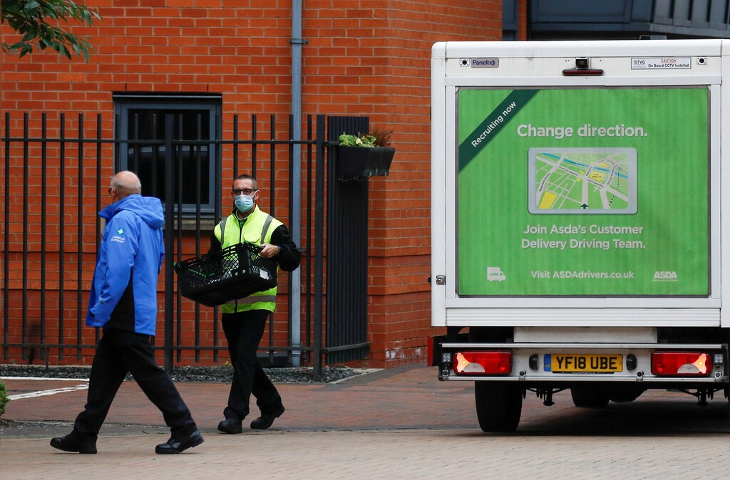 A supermarket delivery driver escorted by a university security guard, delivers food to university students, following the outbreak of the coronavirus disease (COVID-19 in Manchester, Britain, September 28, 2020. REUTERS/Phil Noble - RC2L7J9BFSJ8