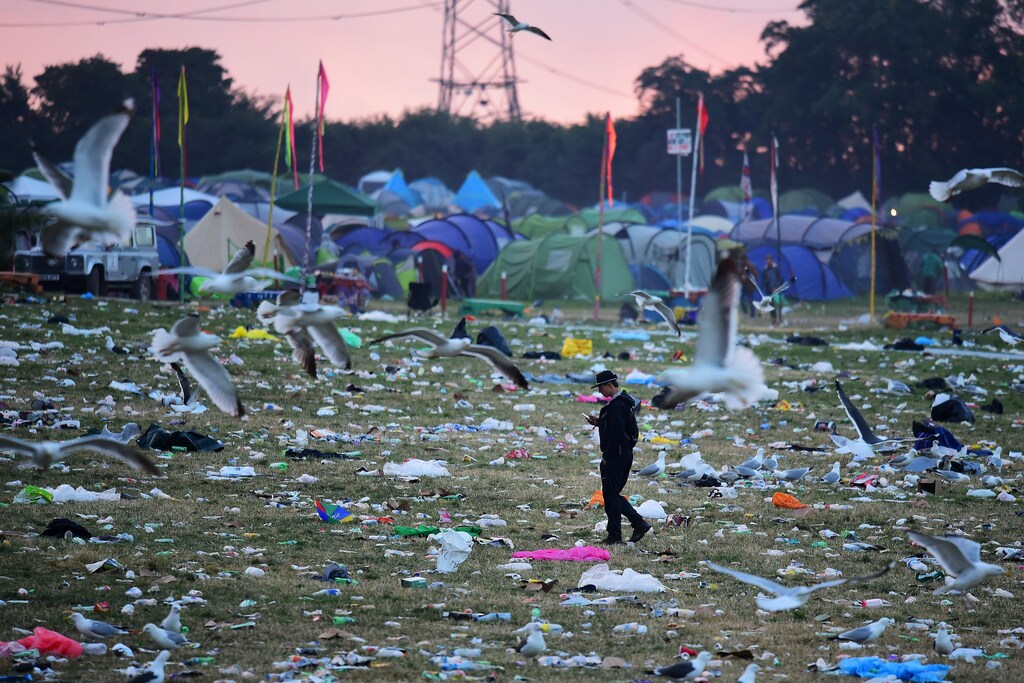 Revellers and detritus are seen near the Pyramid Stage at Worthy Farm in Somerset during the Glastonbury Festival in Britain, June 26, 2017. REUTERS/Dylan Martinez - RC16F704FFF0